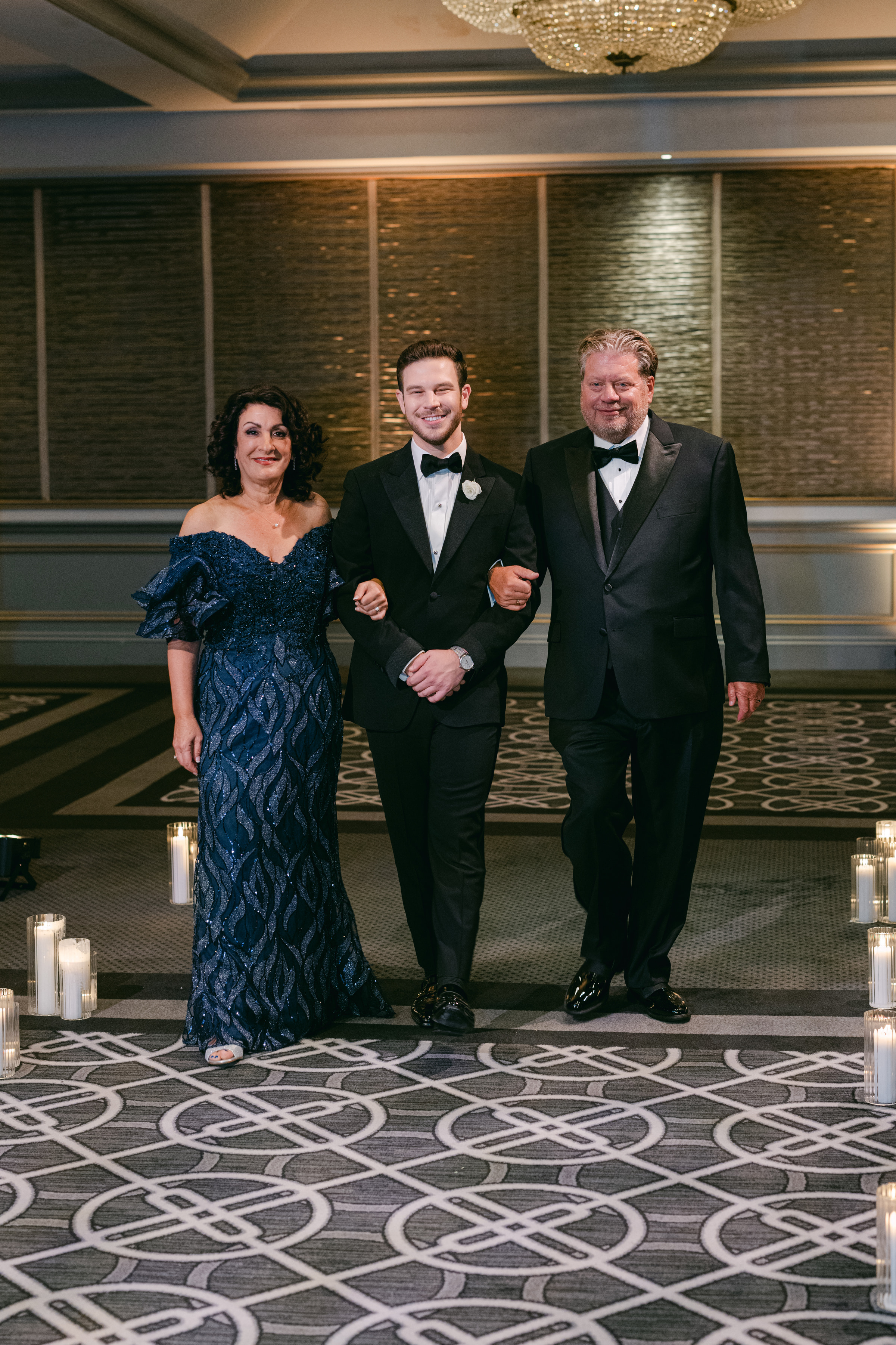 Zack walking into the wedding with his parents